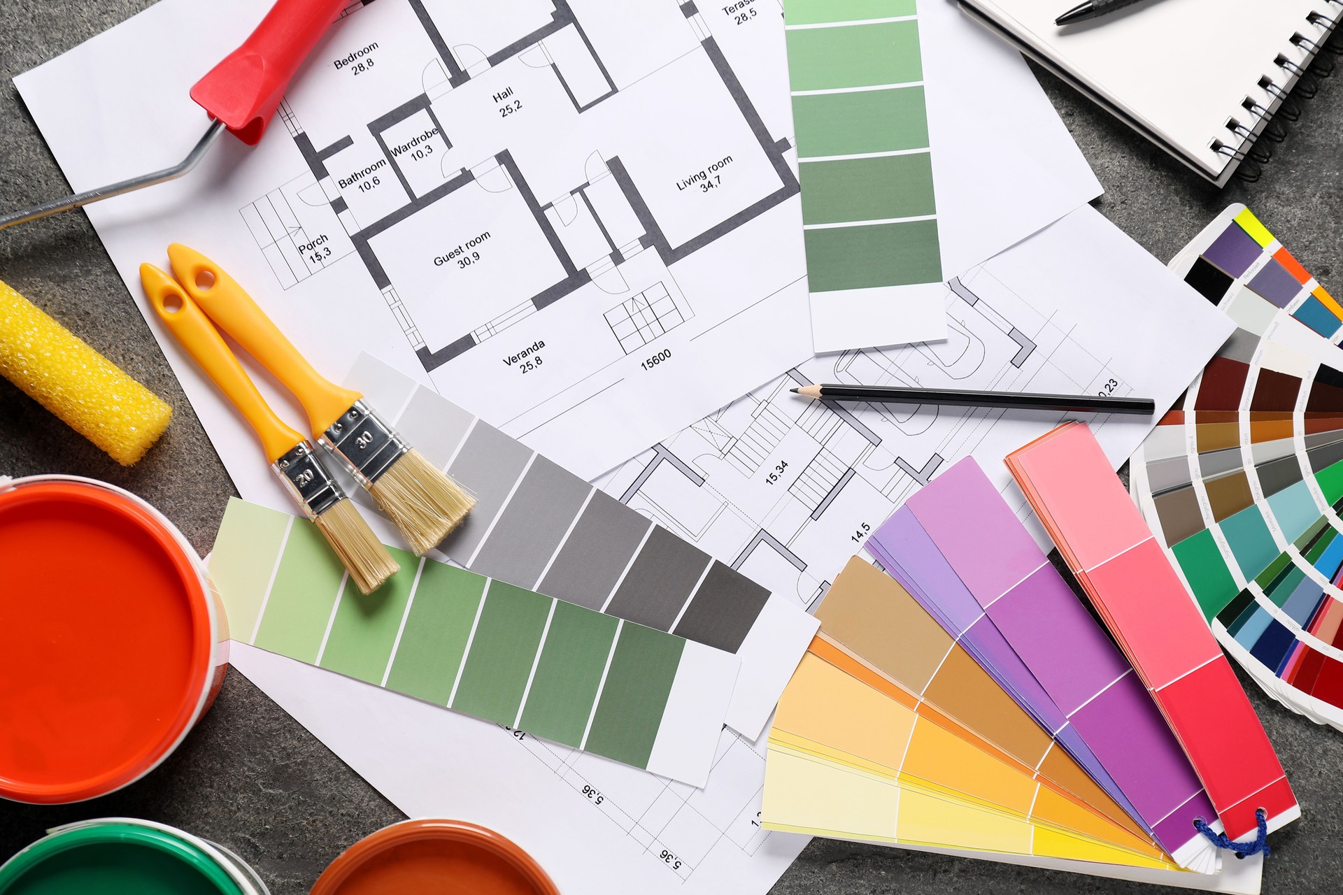 House plans and different decorator's tools on grey table, flat lay